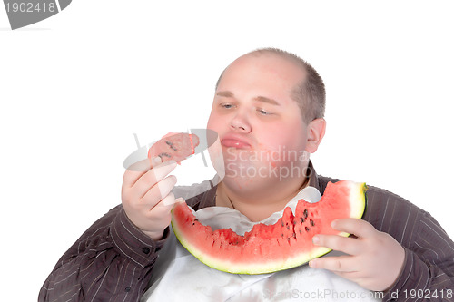 Image of Fat man savouring a slice of watermelon
