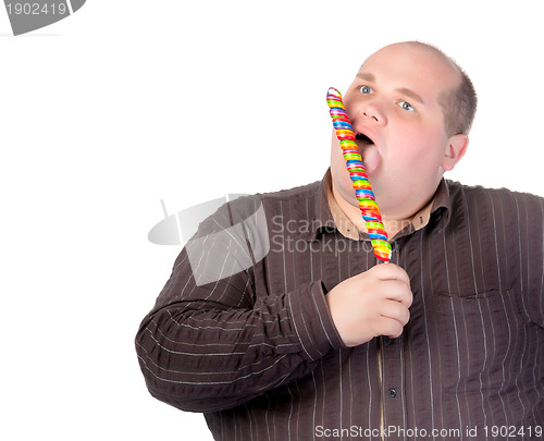 Image of Fat man enjoying a lollipop