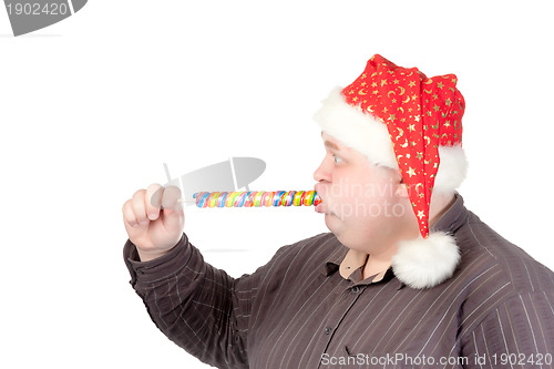 Image of Cheerful fat man in Santa hat