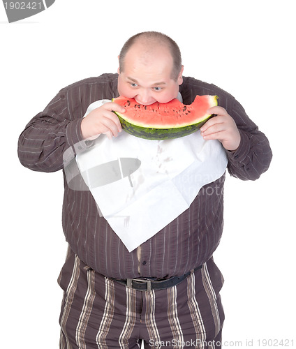 Image of Obese man eating watermelon