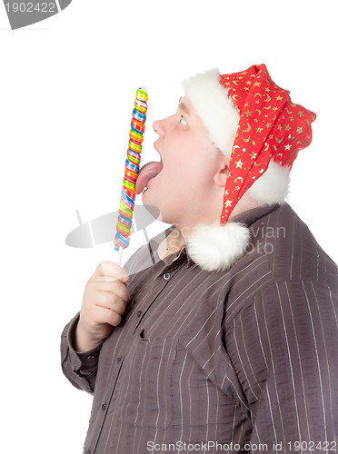 Image of Cheerful fat man in Santa hat