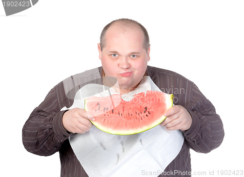 Image of Obese man eating watermelon