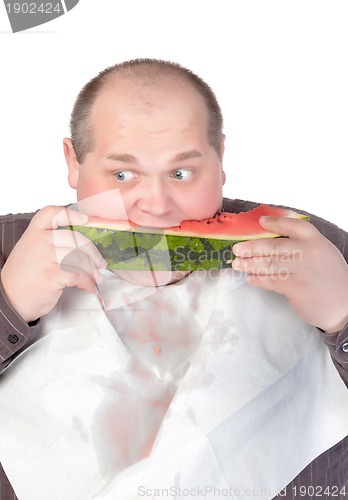 Image of Obese man eating watermelon