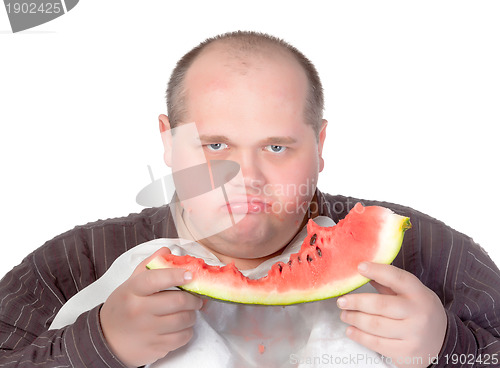 Image of Obese man possessive of his food