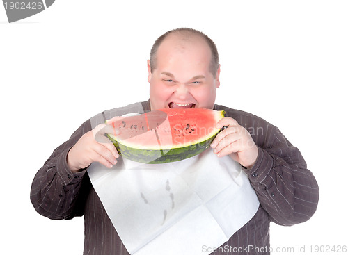 Image of Obese man eating watermelon