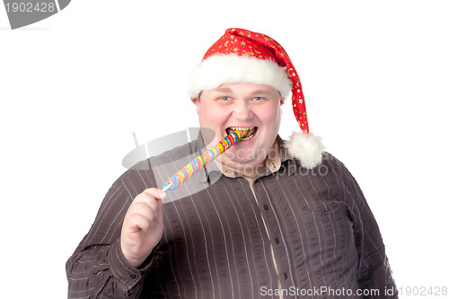 Image of Cheerful fat man in Santa hat