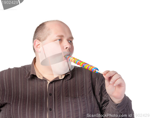 Image of Fat man enjoying a lollipop