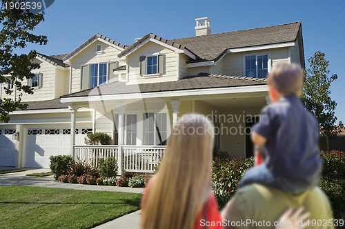 Image of Young Family Looking at a New Home