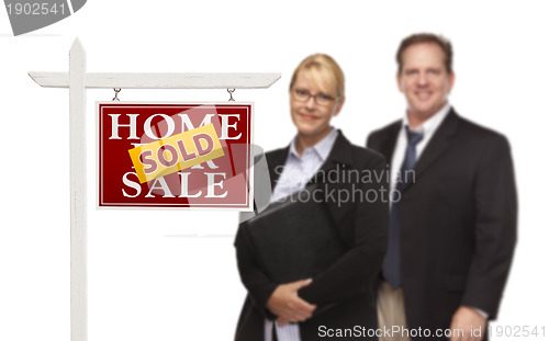 Image of Businesswoman and Businessman Behind Real Estate Sign Isolated