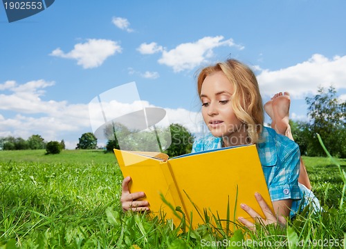 Image of pretty woman laying on lawn