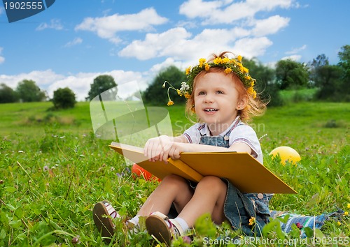 Image of cute girl smiling holding book