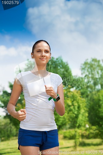 Image of beautiful girl exercising in park