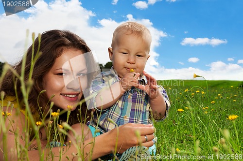 Image of infant sniffing the flower