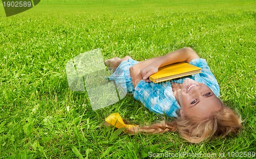 Image of student laughing with book smiling