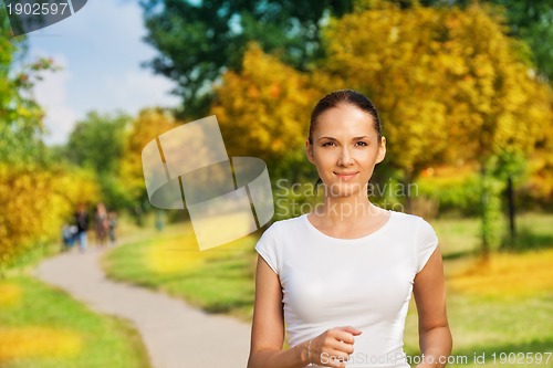 Image of pretty confident woman jogging