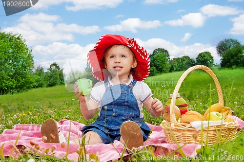 Image of funny little girl holding cup