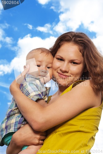 Image of happy mom and son on cloudy background
