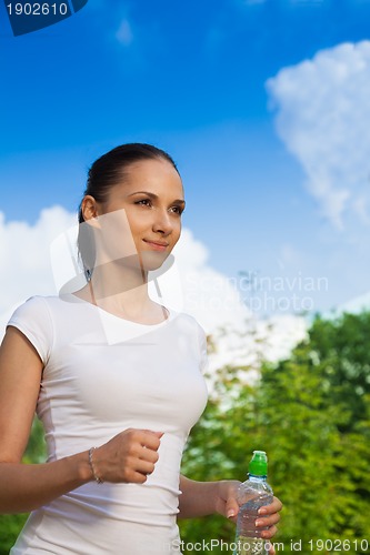 Image of confident woman running in park