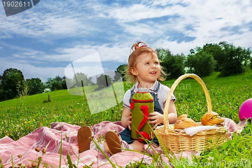 Image of Little girl drinking on picnic