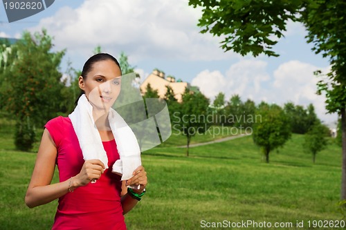 Image of nice girl jogging in the park