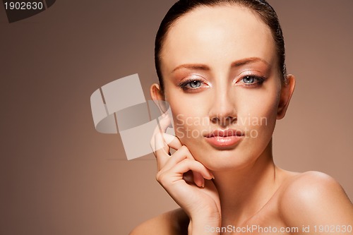 Image of enigmatic woman on chocolate background