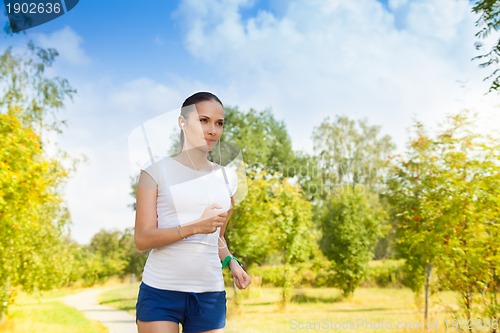 Image of healthy young woman in autumn park