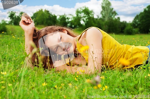 Image of pretty girl resting on grass
