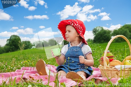 Image of cute girl in ted hat drinking