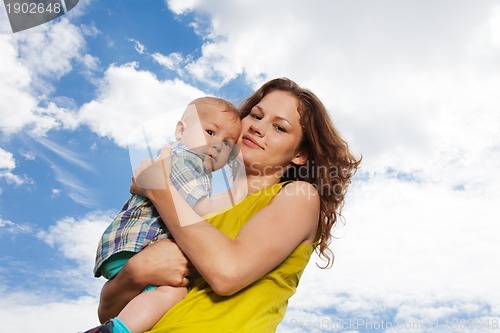 Image of mommy holding her baby in park