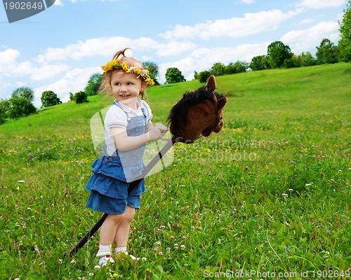Image of happy girl with horse stick