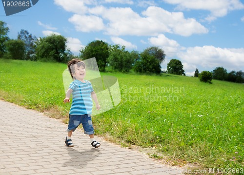 Image of little boy running in park