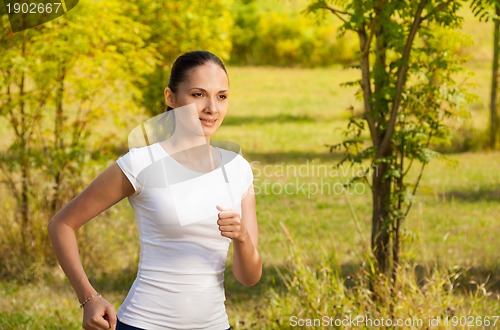 Image of girl running in white t-shirt