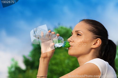 Image of nice girl drinking water from bottle