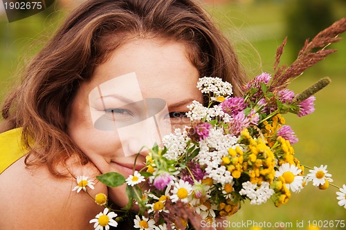 Image of pretty girl smiling with bouquet