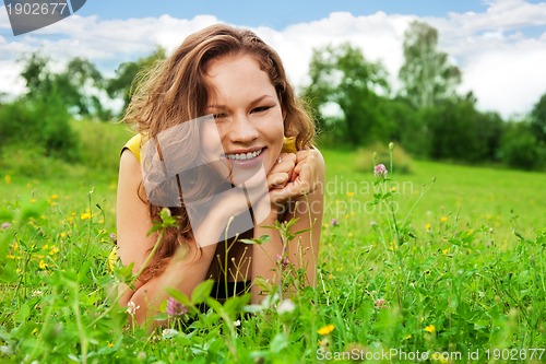 Image of nice girl laying on green grass