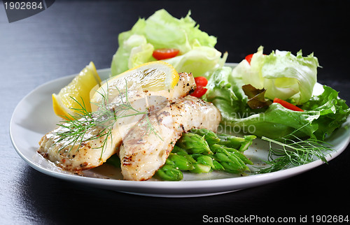 Image of Fish on green asparagus with salad