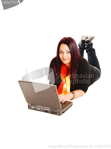 Image of Girl lying on floor with laptop.