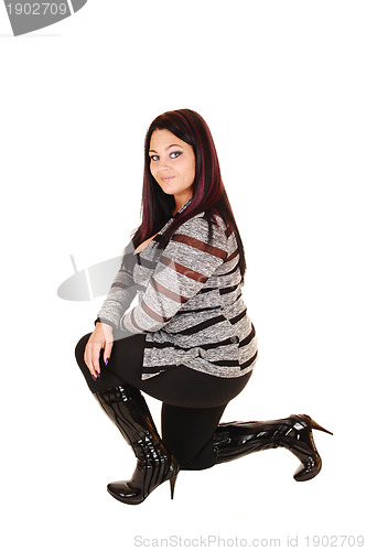 Image of Girl in boots kneeling.