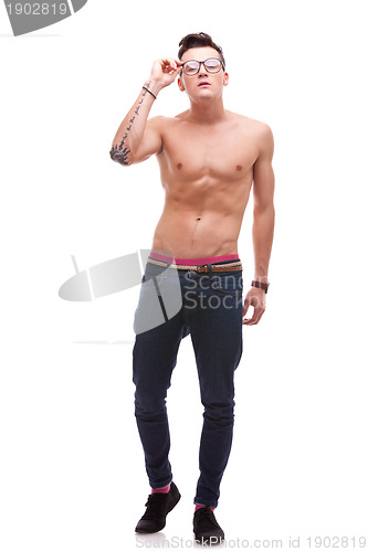 Image of sexy fit man holding his glasses 
