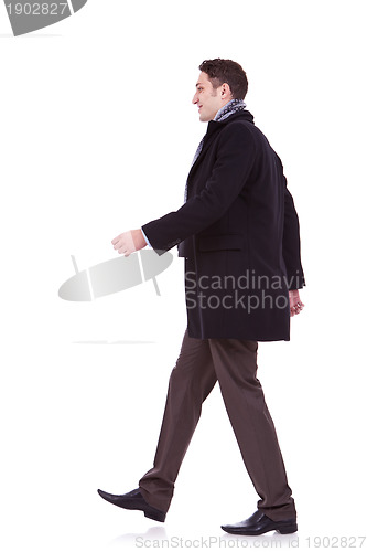 Image of young business man walking forward 