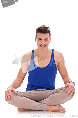 Image of young barefoot man in a yoga position