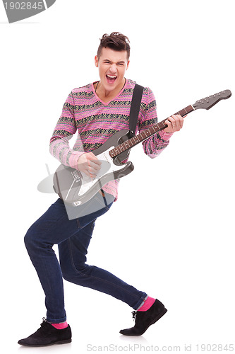 Image of passionate guitarist playing an electric guitar