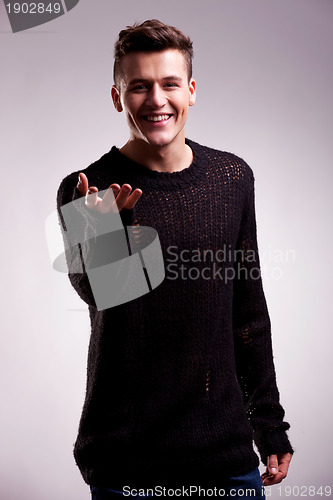 Image of casual man in a sweater welcoming