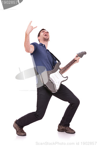 Image of guitarist making a rock and roll gesture