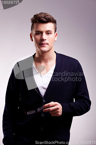 Image of man holding a pair of  glasses