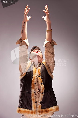 Image of fashion man reaching out for the light