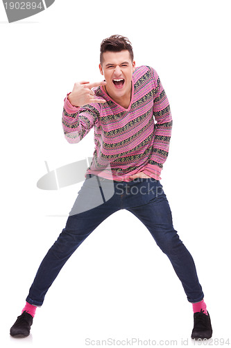 Image of casual  man doing a rock and roll symbol