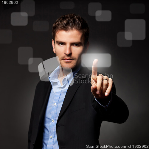 Image of business man pressing a touchscreen button