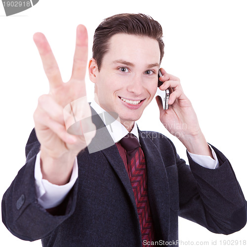 Image of  business man making victory sign on phone