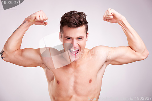 Image of Well-built muscularyoung man screams